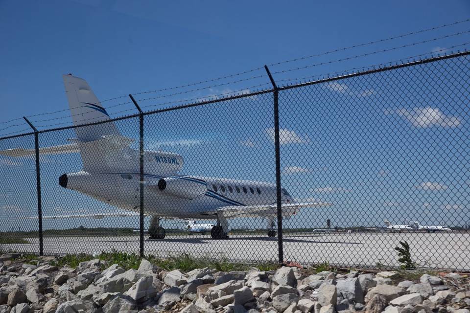 Chain link fences are installed at the airside of airport with barbed wire on the topping.