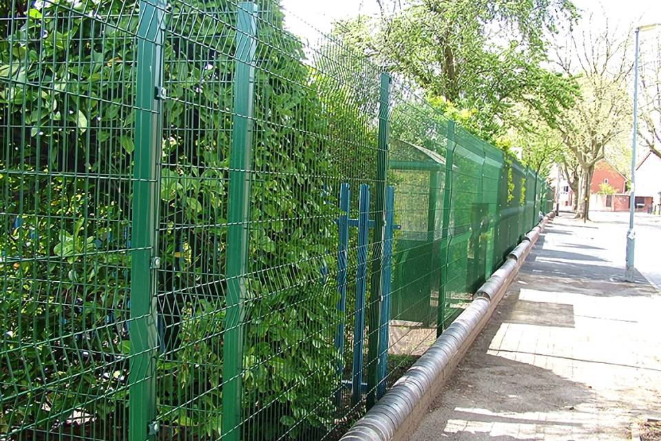 Curvy welded fence is installed along the botanical garden.