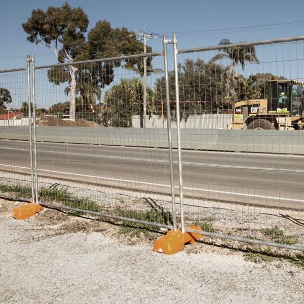 Galvanized Australia temporary fences are installed along the road.