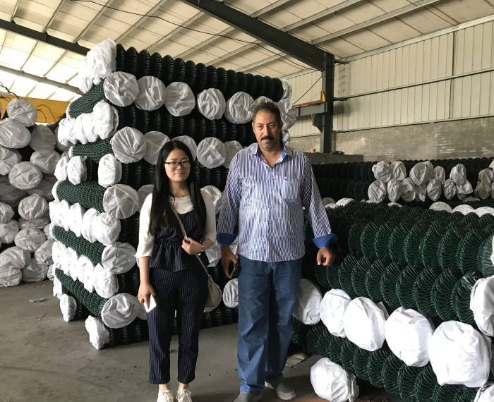 Our customer and our sales representative in the chain link fence warehouse.