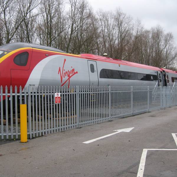 Galvanized palisade fences are installed along the railway.