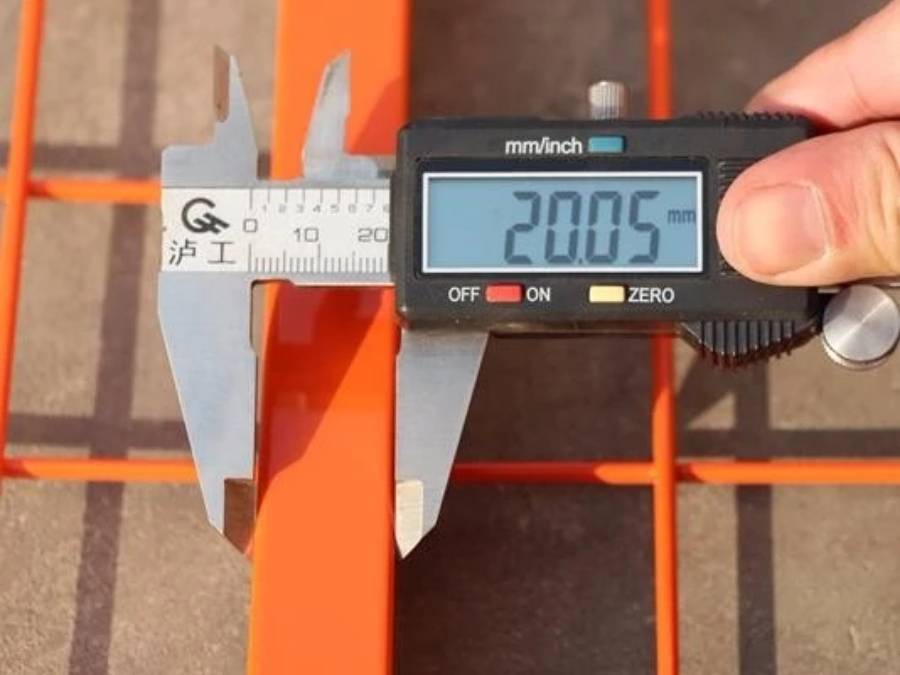 A man is measuring the frame size of Canada temporary fence.