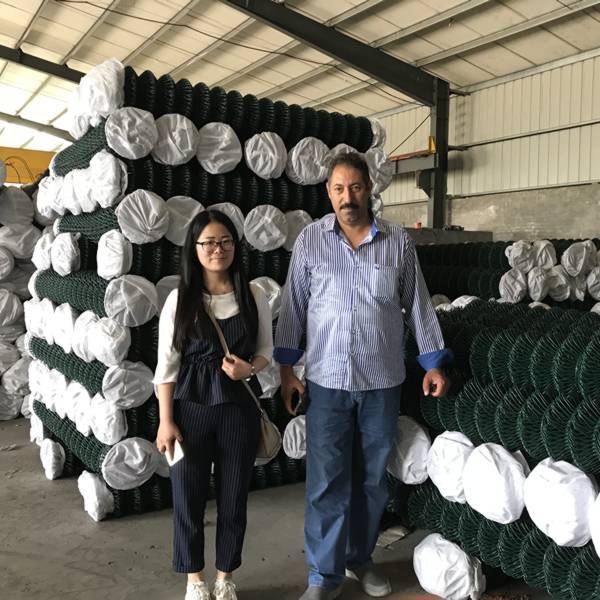 Our sales representative and our customers in the chain link fence warehouse.